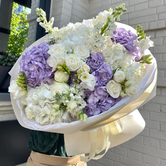 Bouquet of hydrangeas, bush roses, avalanche roses, freesie and matthiola